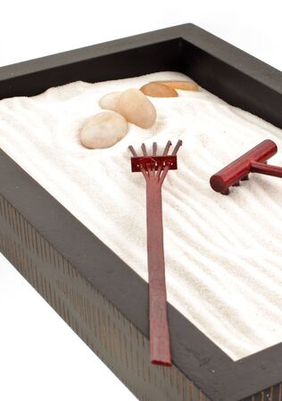mini zen garden with white sand, stones and wood rakesの写真素材