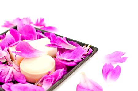 white soap in pink flower petals on a black plate. small GRIPの写真素材