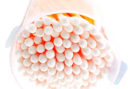 cotton buds in transparent plastic box on a white backgroundの写真素材