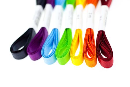 seven rainbow colored ribbons on white backgroundの写真素材