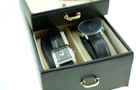 black with silver female watches in a jewelery case. white backgroundの写真素材
