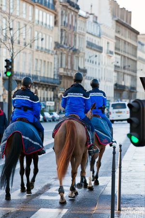french mounted gendarmerie on a street of Paris. Three personsの写真素材