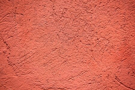 red colored plaster wall background. horizontal shotの写真素材