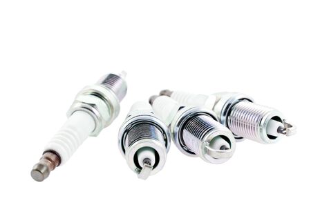 Four Spark Plugs on a white background. horizontal shotの写真素材