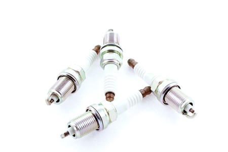 Four Spark Plugs on a white background. horizontal shotの写真素材