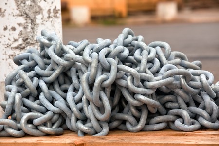 new anchor chain heap on wood board. horizontal shotの写真素材