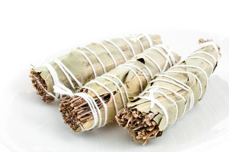 three dry bouquets garni cotton knotted on a white backgroundの写真素材