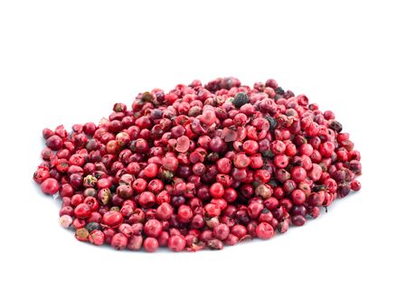heap of pink pepper in corns on a white backgroundの写真素材