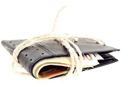 tied black leather wallet with euro notes on white backgroundの写真素材