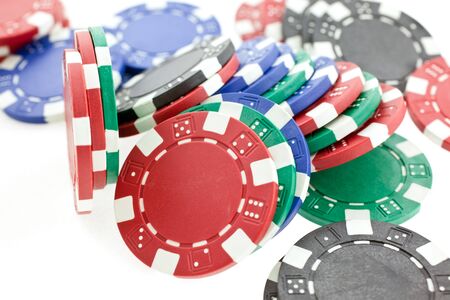 multicolor poker chips heap isolated on white background. closeup horizontal shotの写真素材