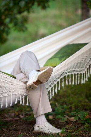 man in light suit in fabric hammock. small GRIPの写真素材