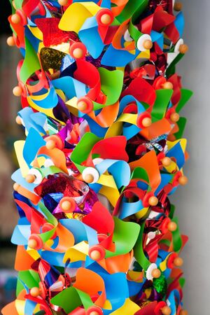 multicolor bright toy pinwheels in a shop. vertical shotの写真素材