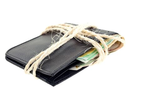 tied black leather wallet with euro notes on white backgroundの写真素材