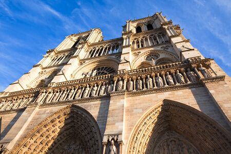 Looking up at the Notre Dame de Paris Cathedral. Horizontal shotの写真素材