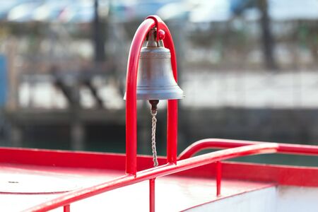 Ship Bell on red arc mount. horizontal shotの写真素材