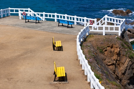 Empty yellow and blue benches at Atlantic sea coastlineの写真素材