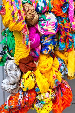 Many bright color cotton scarves on sale. Vertical shotの写真素材