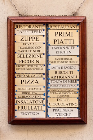 Italian restaurant menu board in a frame on house wallの写真素材