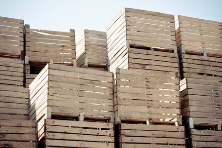 Grunge Crates stack. weathered wooden boxes in tall rows. horizontal toned and vignetted imageの写真素材