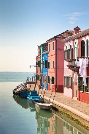 Colorful houses along canal in the island of Burano near Venice, Italyの写真素材