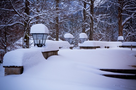 White landscape: snowy lamps near house in the woods.ÊToned and vignetted image as postcardの写真素材