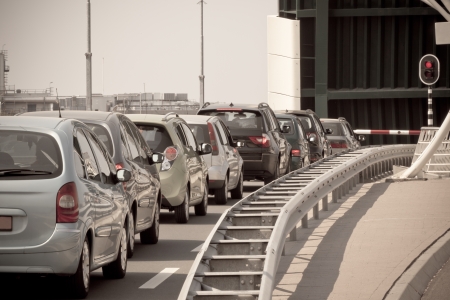Waiting Cars Line Against Red Traffic Light and Open Bridge. Toned imageの写真素材