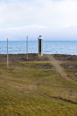 Lighthouse in East Iceland at overcast weather. Vertical shotのeditorial素材