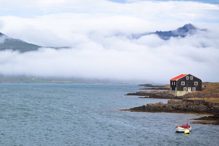 Lonely Black Wooden House at coastline&amp,amp,Ecirc,in East Iceland  Horizontal shotの写真素材