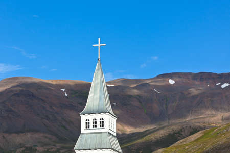 Iceland Church Steeple on bright blue sky and mountains backgroundの写真素材