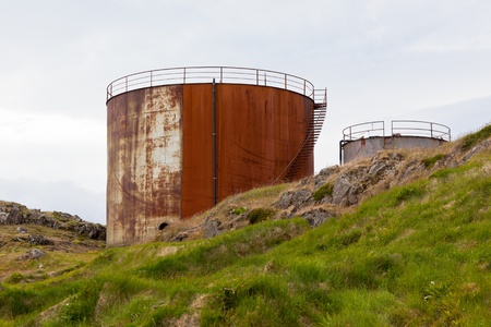 Rusted above ground storage tanks at dull dayの写真素材