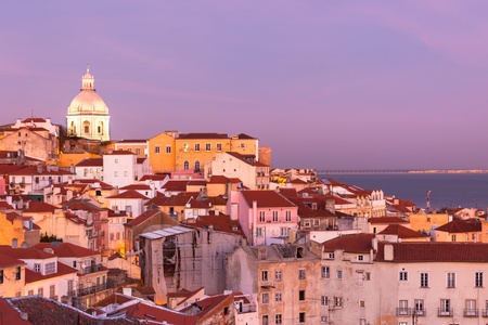 Panorama of old traditional city of Lisbon with red roofs and view of river Tagus at sunsetの写真素材
