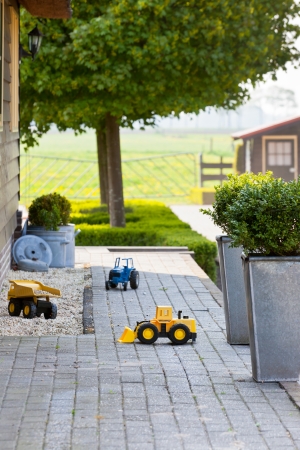 Ghild Toy Cars at Suburban House Back Yard. Vertical shotの写真素材
