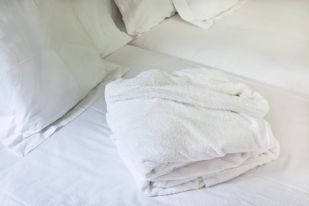 Night scene in hotel room: prepared fresh bed and bathrobeの写真素材