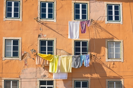 Laundry - Washed clothes hanging outside an old building of Lisbon, Portugalの写真素材