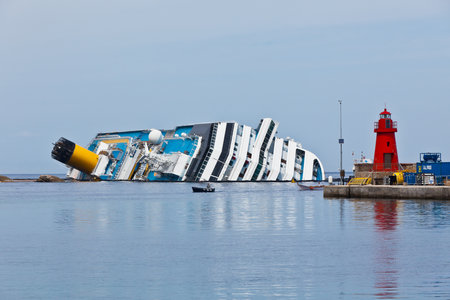 GIGLIO, ITALY - APRIL 28, 2012  Costa Concordia Cruise Ship at Italian Giglio Island Coastline after Shipwreck at January, 13, 2012  The ship, carrying 4,252 people from all over the world, was on the first leg of a cruise around the Mediterranean Sea, stのeditorial素材