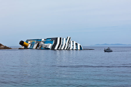 GIGLIO, ITALY - APRIL 28, 2012  Costa Concordia Cruise Ship at Italian Giglio Island Coastline after Shipwreck at January, 13, 2012  The ship, carrying 4,252 people from all over the world, was on the first leg of a cruise around the Mediterranean Sea, stのeditorial素材