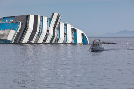 GIGLIO, ITALY - APRIL 28, 2012  Costa Concordia Cruise Ship at Italian Giglio Island Coastline after Shipwreck at January, 13, 2012  The ship, carrying 4,252 people from all over the world, was on the first leg of a cruise around the Mediterranean Sea, stのeditorial素材