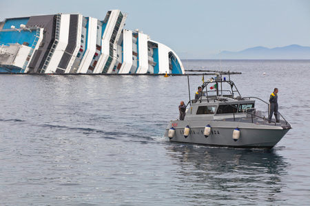 GIGLIO, ITALY - APRIL 28, 2012  Costa Concordia Cruise Ship at Italian Giglio Island Coastline after Shipwreck at January, 13, 2012  The ship, carrying 4,252 people from all over the world, was on the first leg of a cruise around the Mediterranean Sea, stのeditorial素材