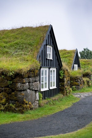 Overgrown Typical Rural Icelandic Houses at Overcast Misty Dayの写真素材