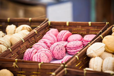 Macarons assortment in a wickered boxes. Horizontal shot with selective focusの写真素材