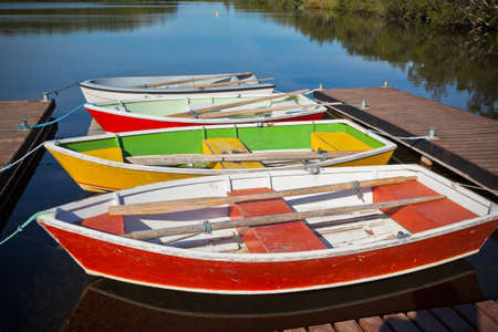 Floating Color Wooden Boats with Paddles in a Lake. Horizontal shotの写真素材