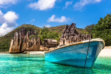 Old fishing boat on Tropical beach at Curieuse island Seychelles. Horizontal shotの写真素材
