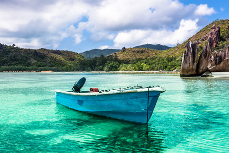 Old fishing boat on Tropical beach at Curieuse island Seychelles. Horizontal shot