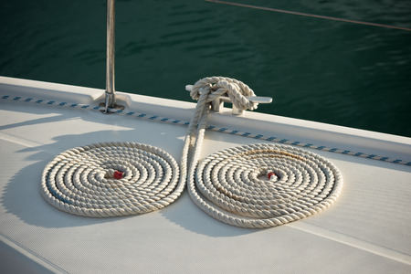 A mooring ropes with a knotted ends tied around a cleatの写真素材
