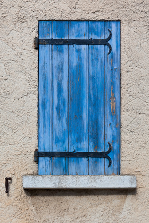 House facade with blue shutters in France. Vertical shotの写真素材
