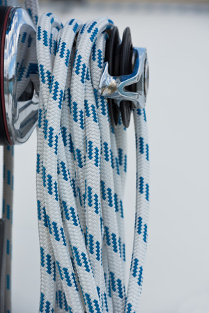Winches and ropes, sailing yacht detail. Vertical shot