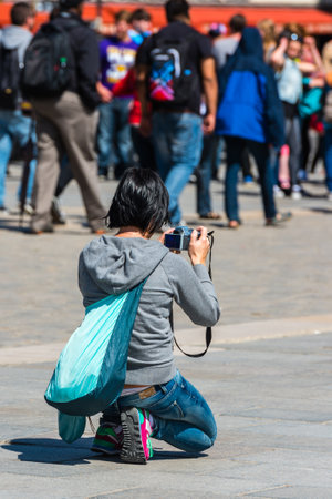FRANCE, PARIS - JUNE 01: Back side of a young woman taking a photo with her camera in Paris on June 01, 2015のeditorial素材