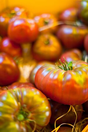 Tomatoes selling in a farmers market. Horizontal shot with selective focusの写真素材