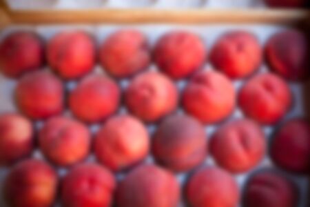 Blur shot of Ripe fresh peaches in a farmers market. Defocusedの写真素材