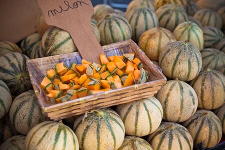 Ripe fresh melons pile in a farmers market. Horizontal shot with a selective focusの写真素材